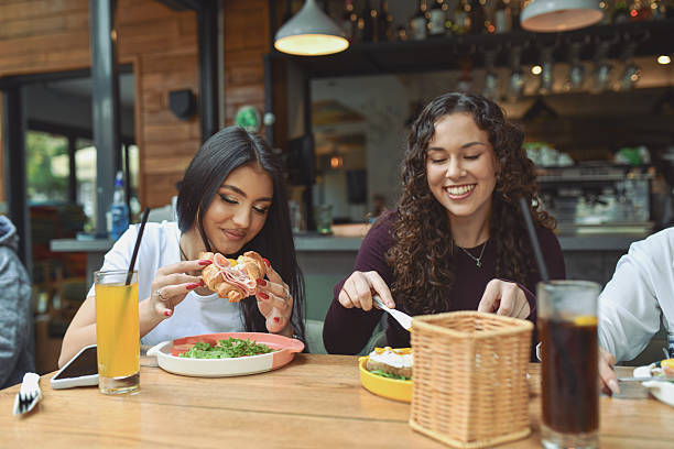 istock Friends Enjoy Breakfast Together At A Modern Lounge Bar 2243790565