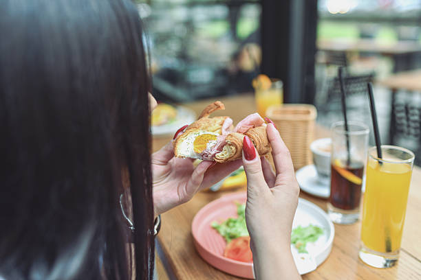 istock Friends Enjoy Breakfast Sandwich At Modern Lounge Bar With Drinks And Fresh Veggies 2243790608