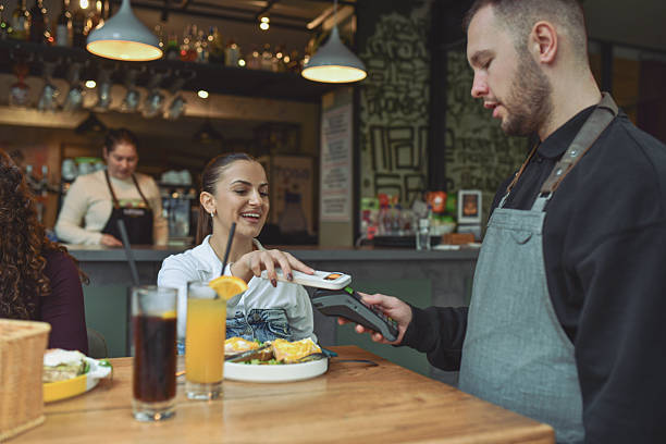 istock Friends Enjoy Breakfast At Modern Lounge Bar With Quick Payment Service And Food Experience 2243790758