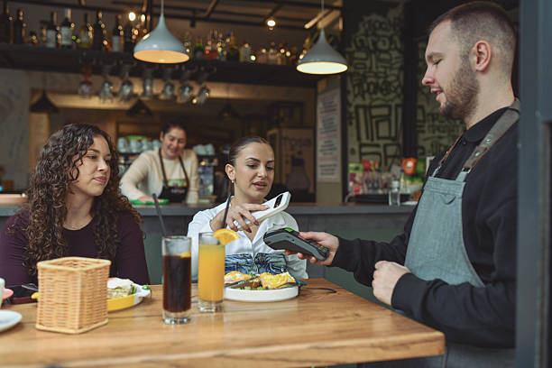 istock Friends Enjoy Breakfast At Modern Lounge Bar With Quick Payment Service And Food Experience 2243790783