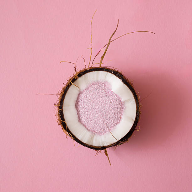 istock Coconut close up with bright sandy powder on a pink backround.Minimal summer concept.Flat lay 2243790842