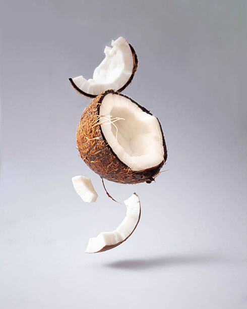 istock Creative food concept made with cracked coconut flaying against bright grey backround.Mimalism. 2243790855