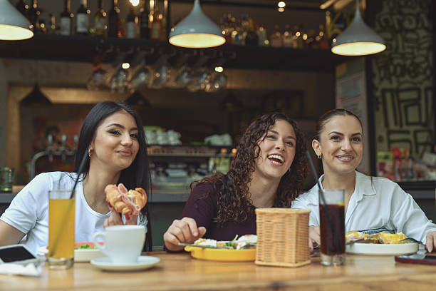 istock Friendly Group Of Women Enjoying Breakfast At A Modern Cafe Bar 2243791981
