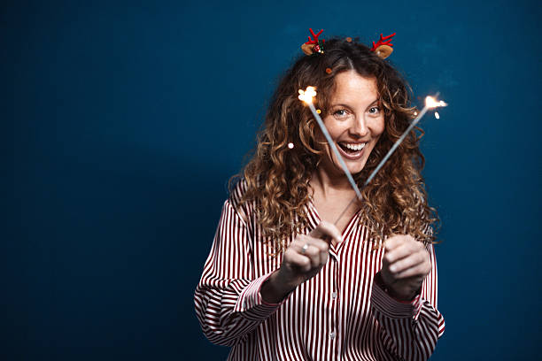 istock Joyful woman celebrating with sparklers and smile 2243792006