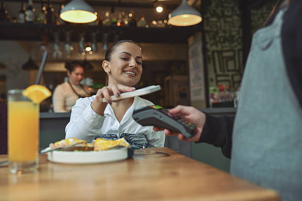 istock Bright Breakfast Moment With Phone Payment At Modern Lounge Bar Table 2243792017