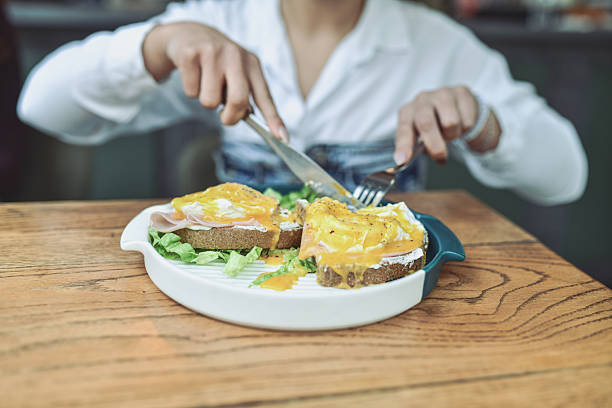 istock Breakfast Sandwiches With Egg, Cheese, Ham, And Greens On Toast In A Modern Lounge Setting 2243792258
