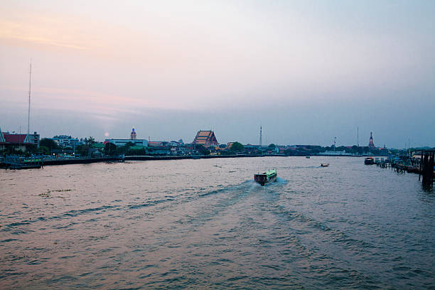 This unique photo shows how the old traditional long-tail boats sailing on the Mae Nam Chao Phraya River in Bangkok