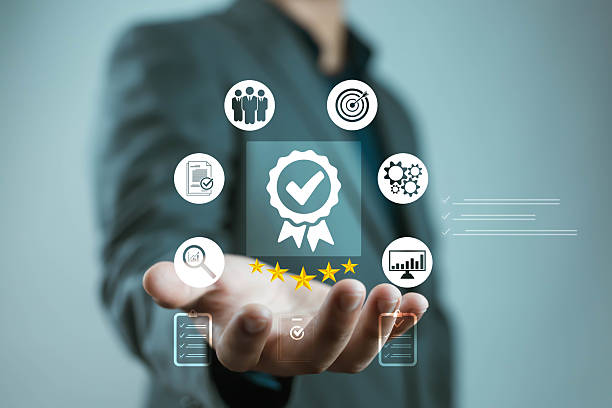 istock Businessman presenting quality assurance and certification icons with five stars, symbolizing business excellence, customer satisfaction, performance evaluation, and professional management standards. 2243798273