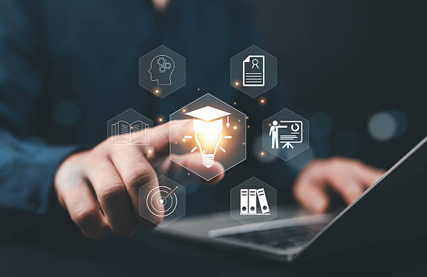 istock Person using laptop with glowing graduation cap and light bulb icon, representing innovation in online education, e-learning, digital knowledge, creativity, and smart technology for modern learning. 2243798404