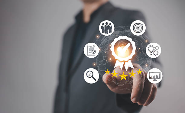istock Businessman pointing at glowing quality assurance icon with five stars, symbolizing certification, trust, customer satisfaction, performance excellence, and business standards in digital management. 2243798406