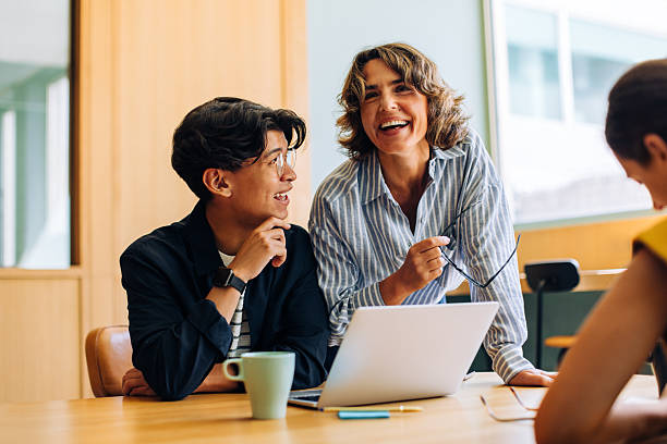istock Professionals engaged in lively discussion around a laptop during a meeting 2243799108