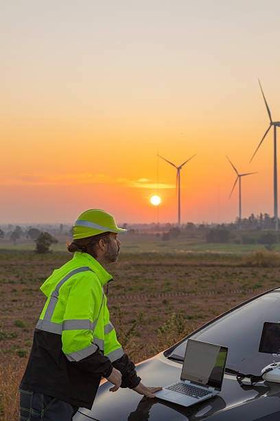 istock Survey Team Alternative energy for future. Engineers survey and checking wind turbines in sunset. Wind Turbine Renewable energy technology and sustainability. 2243799405