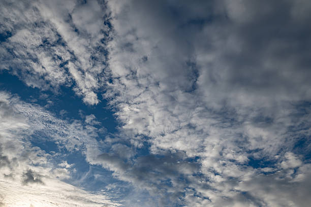 istock Patches of blue sky with dramatic, dark clouds in various textures. Ideal for weather, atmosphere, and abstract sky themes. 2243799799