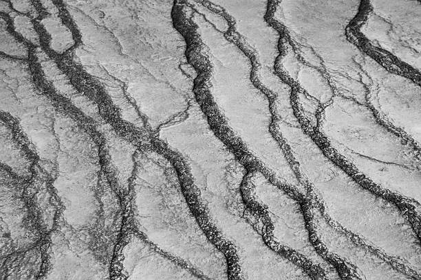 istock Black-and-white naturl hot spring surface with weathered channels — abstract texture 2243799980