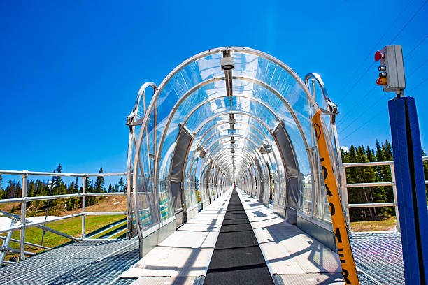 istock Entrance to covered “magic carpet” conveyor at ski area — loader sign & control panel 2243800193