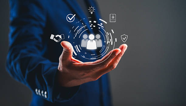 istock A business professional holds a hand with digital icons representing teamwork, communication, and protection in a modern, abstract design. 2243802560