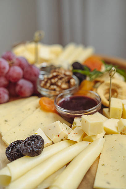 istock Close up on sliced ​​cheese on a wooden board. 2243802619