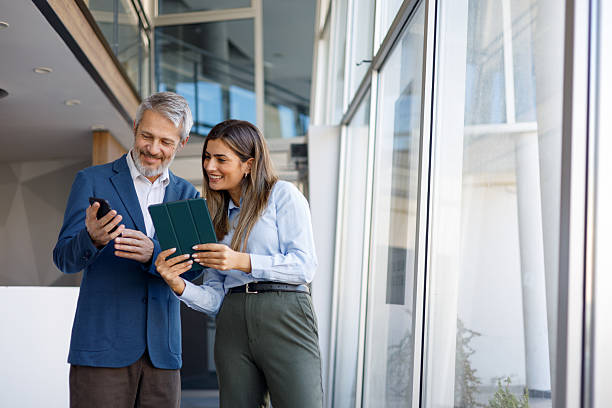 istock Business colleagues collaborating on digital tablet and smartphone, sharing ideas in modern office building 2243804511