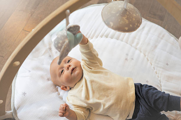 istock Four Month Baby Boy on Floor Reaching and Exploring Activity Toy 2243806181