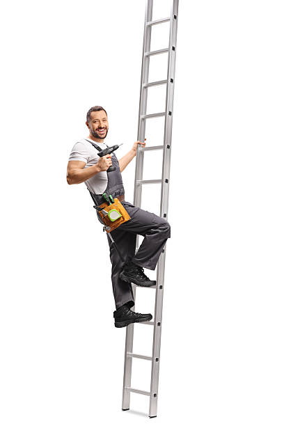 istock Repairman with a drilling machine on a ladder 2243806754