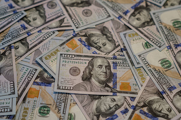istock Colorful Hundred Dollar Bills Scattered on a Surface, Showcasing the Vibrant Design and Detailed Features of the Currency 2243808991