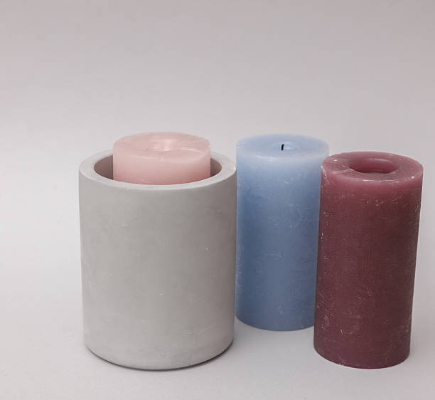 Concrete mold with candles on gray background