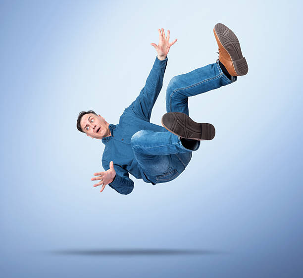 istock Surprised man in casual clothes falling down with arms spread, on blue gradient background, concept of failure, accident, shock, losing balance, or business risk 2243810317