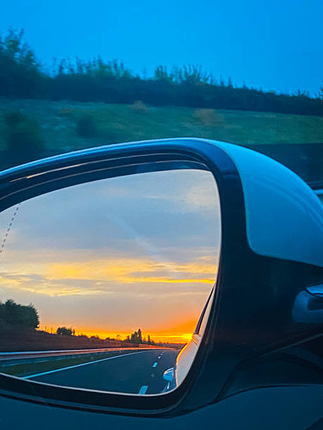 istock Sunset view in the car mirror. 2243811834