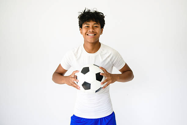 istock nice Boy with soccer ball on studio white background 2243812109