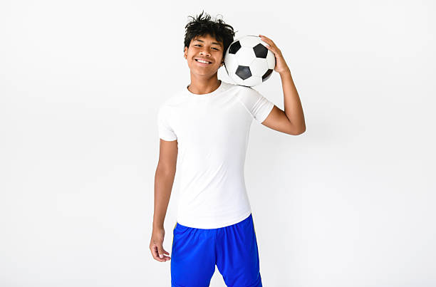 istock nice Boy with soccer ball on studio white background 2243812111