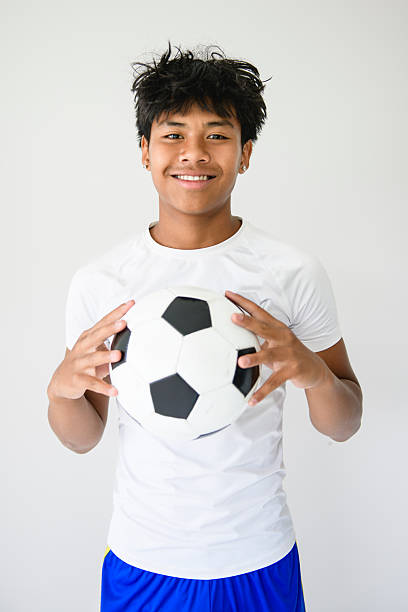 istock nice Boy with soccer ball on studio white background 2243812126