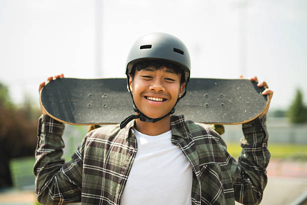 istock nice Boy with skateboards outside on skate playground 2243814022