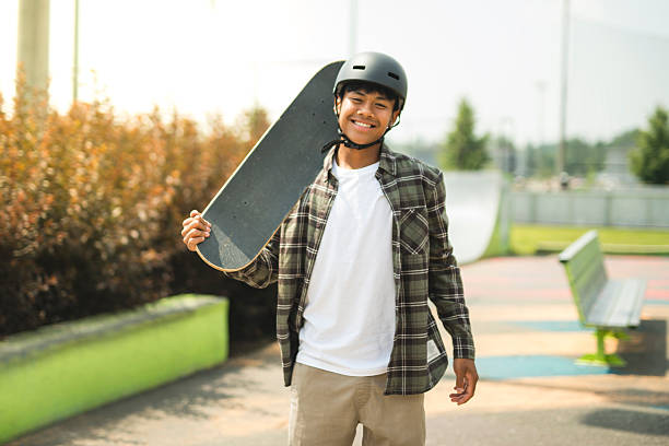 istock nice Boy with skateboards outside on skate playground 2243814023