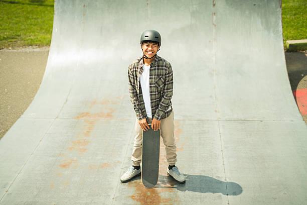 istock nice Boy with skateboards outside on skate playground 2243814053