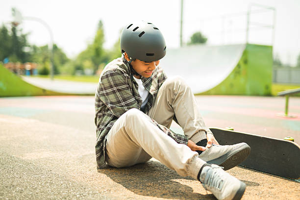 istock nice Boy with skateboards outside on skate playground having head injury 2243814081