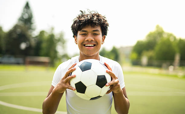 istock nice Boy with soccer ball outside on field 2243814106