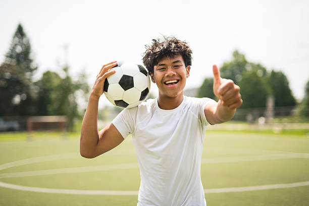 istock nice Boy with soccer ball outside on field 2243814117