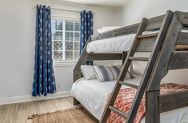 istock Kids teens boys bedroom interior with wood frame bunk bed 2243814925