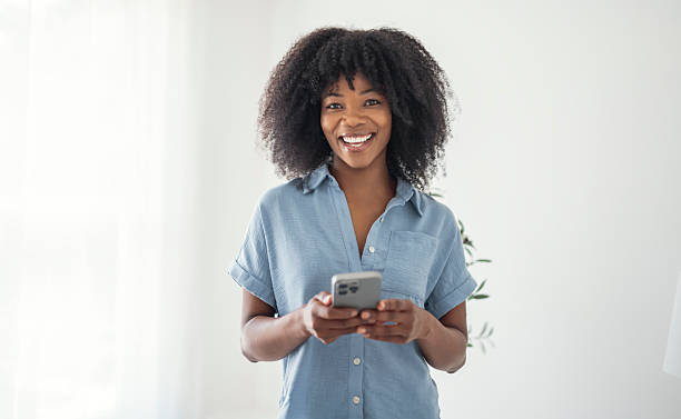 istock black business mature woman using cellphone on white background 2243815476