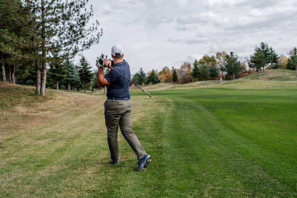 istock Male golf player swinging golf club on fairway 2243815480