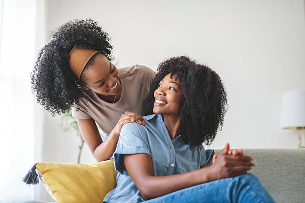 istock A affectionate mother and daughter sitting on sofa at home 2243815543