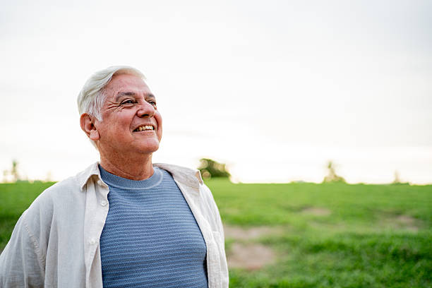 istock Senior man looking away contemplating on a public park 2243815806