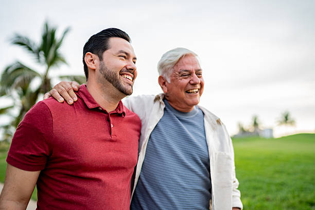 istock Father and son talking while walking on public park 2243815807