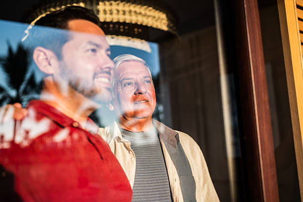 istock Father and son looking through window at home 2243815833