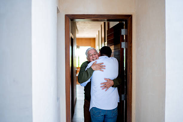 istock Senior man welcoming son at home 2243816036