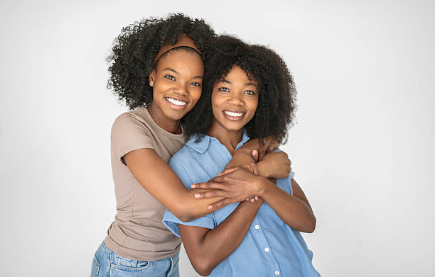 istock Affectionate mother and daughter portrait close to a white wall 2243818873