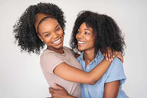 istock Affectionate mother and daughter portrait close to a white wall 2243818885