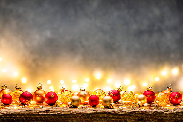 Christmas decoration background with copy space. Cozy atmosphere or warm lights and colored Christmas balls making a frame. December or greeting card