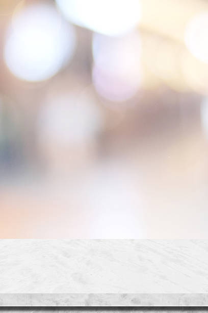 istock Empty vertical white table top, counter, desk background over blur  bokeh background, White marble stone table, shelf and blurred kitchen restaurant for food, product display mockup, template 2243823727