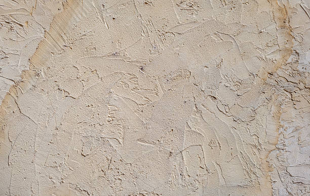 istock textured wall surface features intricate patterns and varying shades of beige, illuminated by soft natural light. details create warm and inviting atmosphere, ideal for artistic inspiration 2243828138